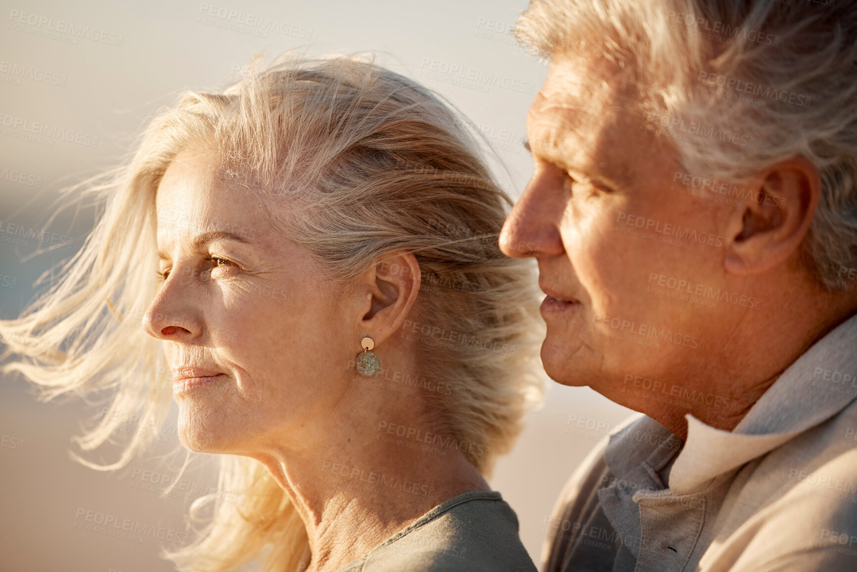 Buy stock photo Mature couple enjoying the view on the beach. Senior couple bonding on holiday together by the sea. Mature being affectionate on the beach on holiday. Closeup on faces of mature husband and wife