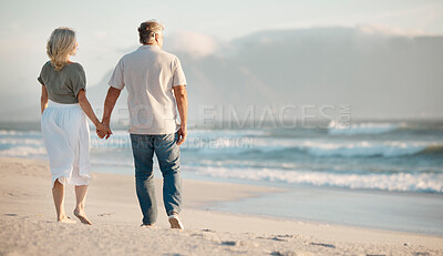 Buy stock photo Love, back view of married couple holding hand and at the sea walking together for bonding time. Holiday break or summer vacation, care and senior people hold hands for romantic walk by the ocean