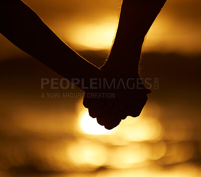 Buy stock photo Couple, silhouette and holding hands at sunset on a beach for vacation or holiday outdoor. Closeup of man and woman in nature for peace, calm and love at ocean for creative shadow, travel or freedom 