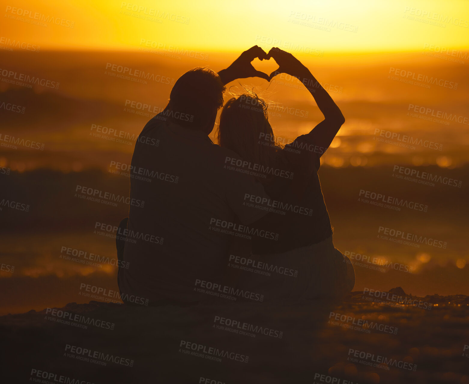 Buy stock photo Silhouette, couple and heart shape at sunset on beach for vacation, holiday or emoji outdoor. Back of man and woman in nature with creative sky, hand icon and ocean for love, art and travel freedom 