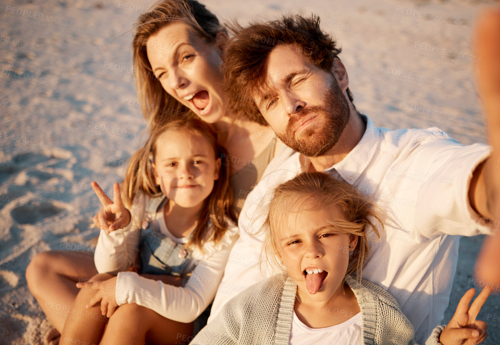 Buy stock photo Family taking a selfie on the beach. Carefree family enjoying a holiday by the beach. Happy family taking a photo during vacation on the beach. Parents enjoying a holiday with their little children
