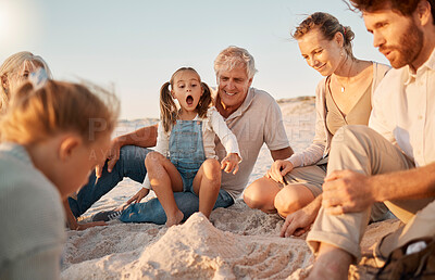 Buy stock photo Parents building a sandcastle with their children. Family enjoying a beach holiday together. Little girls playing with their family on the beach. Carefree family bonding during vacation together