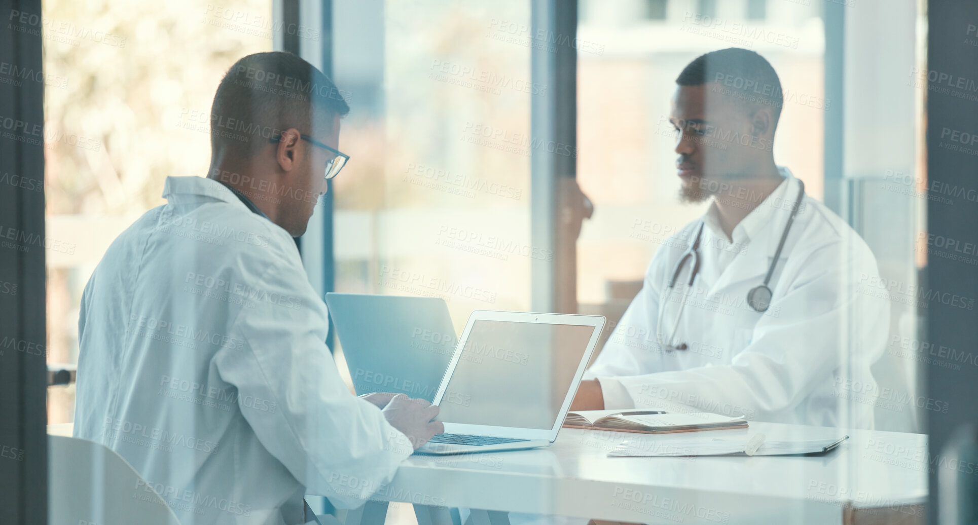 Buy stock photo Meeting, laptop and team of doctors for healthcare coworking, discussion and online management. Working, typing and medical people on computer, telehealth and research behind glass window in office