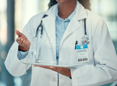 Hand of a doctor holding a digital tablet in the hospital. Closeup on hand of a doctor making a gesture while using a wireless device. Medical professional browsing an online app on a digital tablet