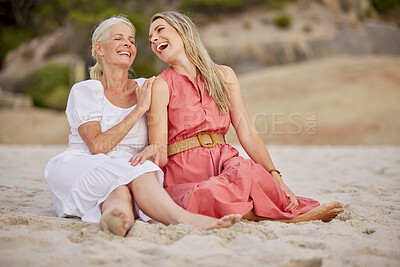 Buy stock photo Closeup of a senior caucasian woman smiling and spending time with her daughter on vacation at the beach while sitting on the sand