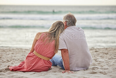 Buy stock photo Rear view of a caucasian father and daughter sitting on the sand at the beach together and bonding looking at the view