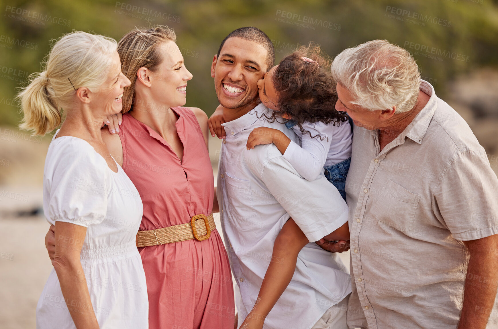 Buy stock photo Closeup of a senior caucasian couple at the beach with their children and grandchild. Mixed race family relaxing on the beach having fun and bonding
