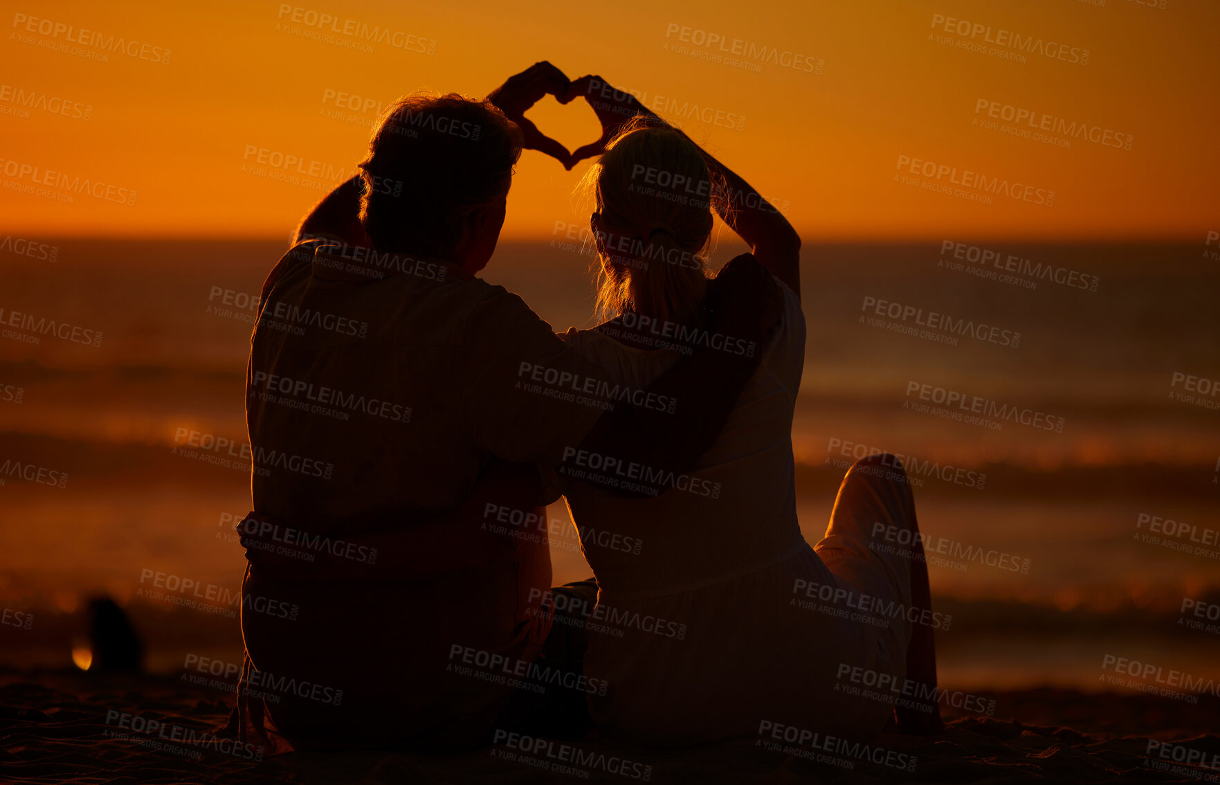 Buy stock photo Love, beach and silhouette of couple heart hands, bonding holiday and tropical island evening Nature, man and woman on ocean date together with romantic gesture, sunset sky or outdoor vacation travel