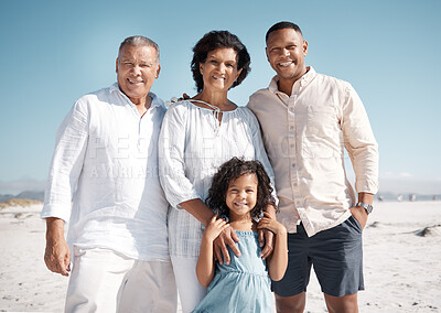 Buy stock photo Smiling mixed race family standing together on a beach. Hispanic grandmother and grandfather bonding with son and granddaughter over weekend. Adorable little girl enjoying free time with single father