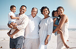 Portrait of smiling mixed race family with little boy and girl standing together on a beach. Adorable little son and daughter bonding with mother, father, grandmother and grandfather over a weekend
