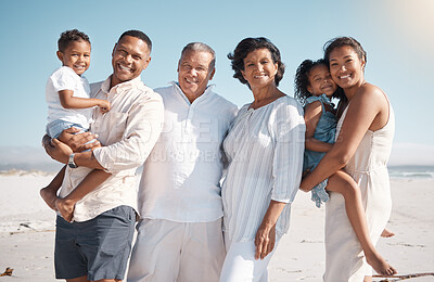 Buy stock photo Portrait of smiling mixed race family with little boy and girl standing together on a beach. Adorable little son and daughter bonding with mother, father, grandmother and grandfather over a weekend