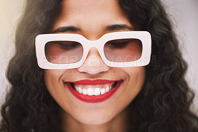 Buy stock photo Fashion, face and glasses with a model woman posing with a smile and sunglasses or eyewear in studio on a gray background. Head, style and confident with a young female wearing red lipstick inside