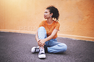 Fullbody beautiful mixed race fashion woman looking thoughtful and smiling against an orange wall background in the city. Young hispanic woman looking stylish and trendy. Fashionable and carefree