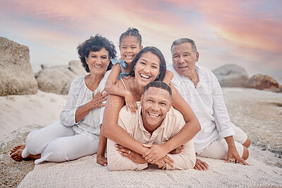 Buy stock photo Portrait of a senior hispanic couple at the beach with their children and grandchild.  Mixed race family relaxing on the beach having fun and bonding