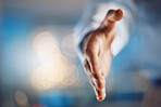 Closeup hand of african man gesturing for a handshake. African american business man standing with his hand out while working late night in office. Making a deal, agreement, merger or partnership