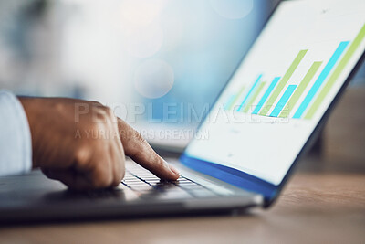 Closeup hands of african man working on a laptop. African american business man using a computer while working late at night in his office. Putting in overtime after hours to ensure success and growth