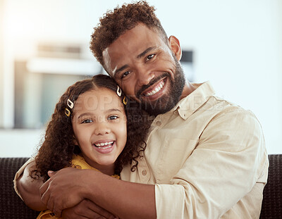 Portrait of mixed race single father and daughter hugging in home living room. Smiling hispanic girl embracing and bonding with single parent in lounge. Happy man and child sitting together on weekend