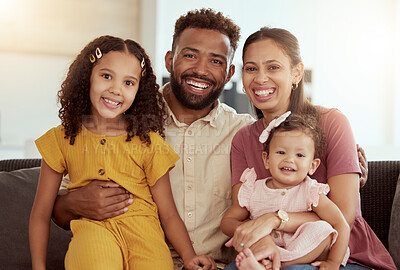 Buy stock photo Portrait of mixed race parents enjoying weekend with cute daughters in home living room. Smiling hispanic girls bonding with mother and father in lounge. Happy couple sitting together with children