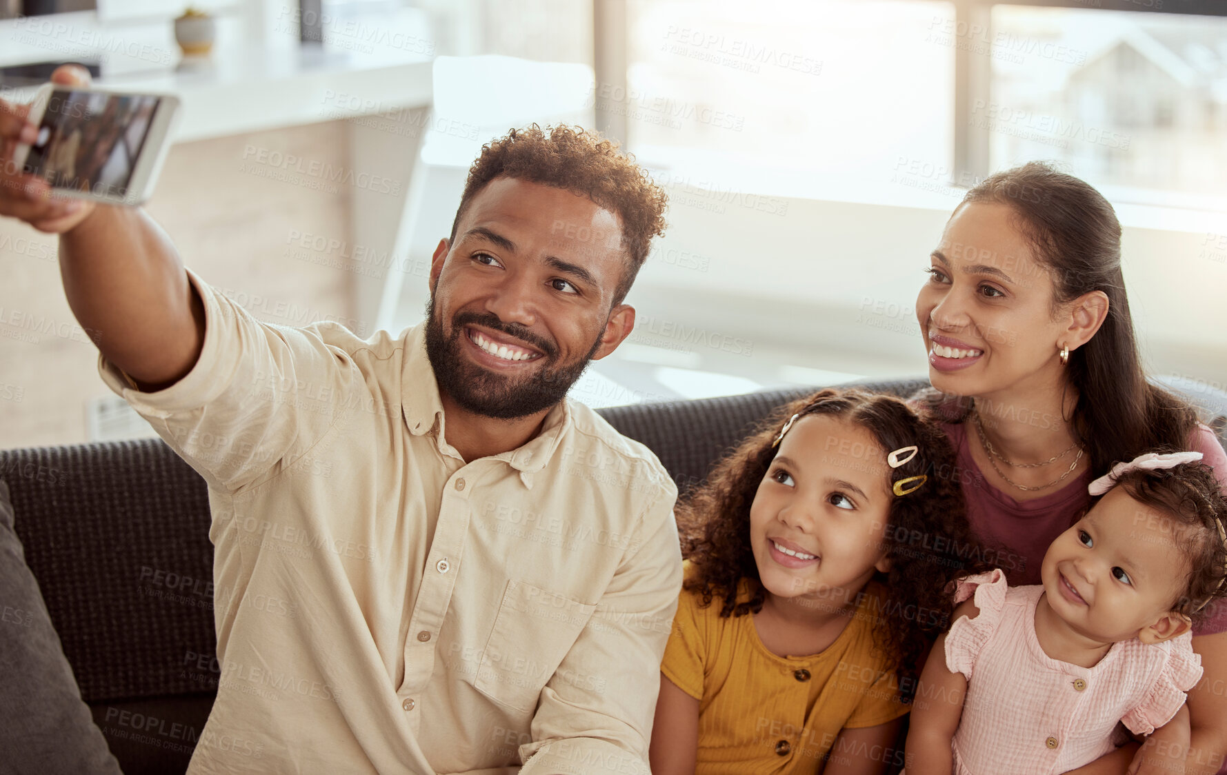 Buy stock photo Parents, girl children and selfie on sofa with happiness, love and bonding for social media app in family home. Father, mother and daughters with photography, profile picture or together for web blog