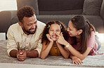 Mixed race parents enjoying weekend with cute daughter in home living room. Smiling adorable hispanic girl bonding with mother and father in lounge. Happy couple lying together with child on weekend
