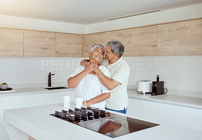 Buy stock photo Mixed race senior couple hugging in the morning at home. Smiling elderly husband and wife holding each other and embracing in kitchen. Happy retired ethnic man and woman bonding and feeling in love