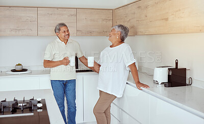 Buy stock photo Mixed race senior couple enjoying coffee in the morning at home. Smiling elderly husband and wife standing together and drinking tea in kitchen. Happy retired ethnic man and woman laughing and bonding