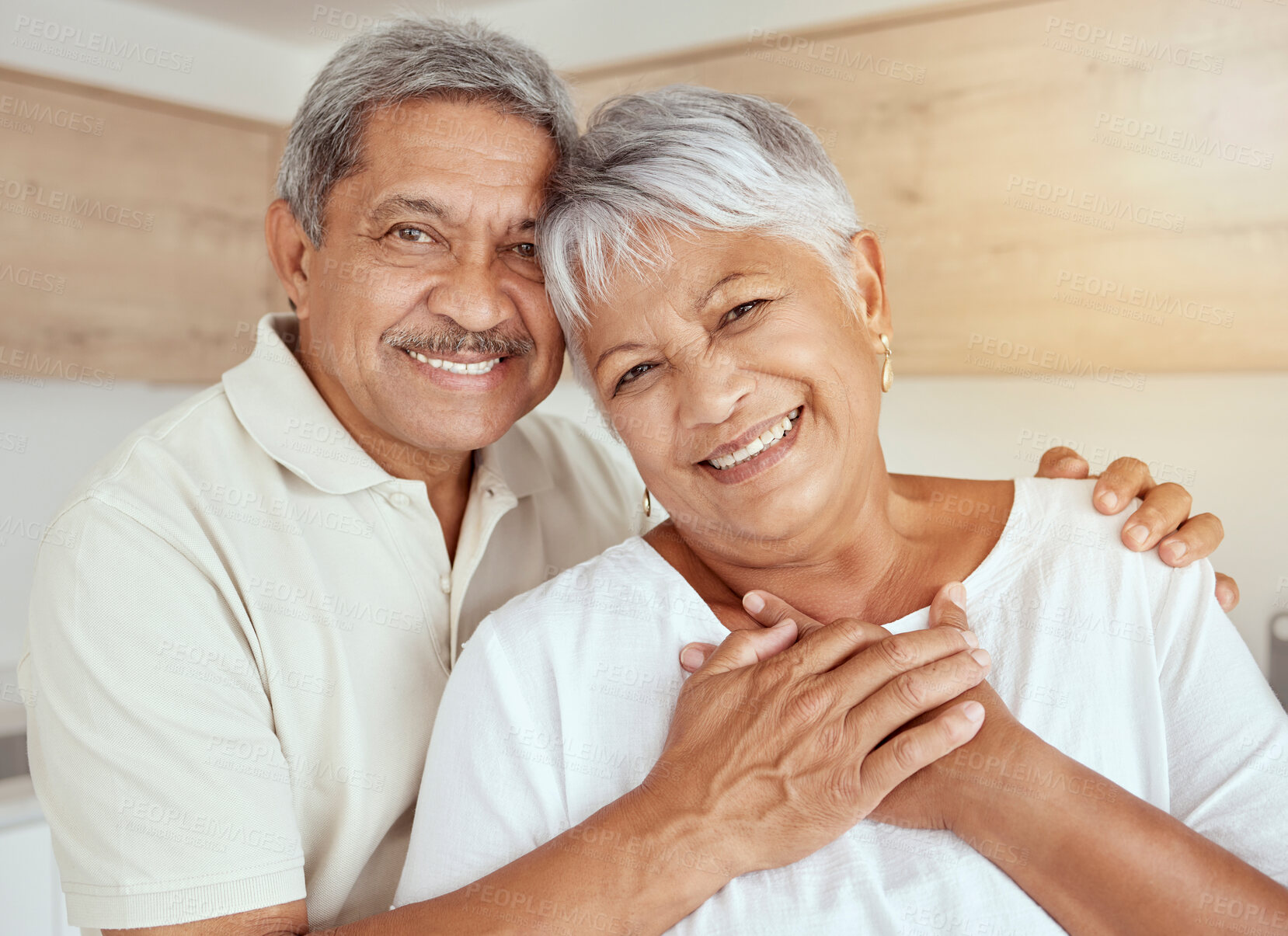 Buy stock photo Portrait, love and senior couple hug in a living room, happy and relax in their home together. Face, smile and holding hands by old people embrace, loving and enjoying retirement in their house