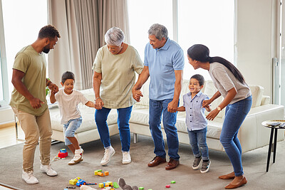 Buy stock photo Mixed race family having fun and dancing in the living room at home. Little boys and grandparents having a fun day at home with their parents. Having dance battle with fun family