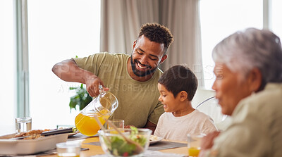 Buy stock photo Closeup of a mixed race male and his son enjoying some food at the a table during lunch at home in the lounge. Hispanic father smiling and eating alongside his son at home