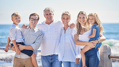 Buy stock photo Close up of happy caucasian multi-generation family standing together on seaside promenade on a sunny day. Two little children enjoying time at the beach with their parents and grandparents