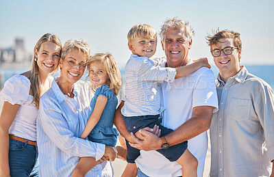 Buy stock photo Portrait of happy caucasian multi-generation family standing together at the beach on a sunny day. Two little children enjoying time at the beach with their parents and grandparents