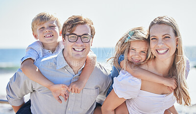 Buy stock photo Portrait of happy caucasian family with two children spending time together at the beach while on vacation. Loving parents carrying their little daughter and son on their backs
