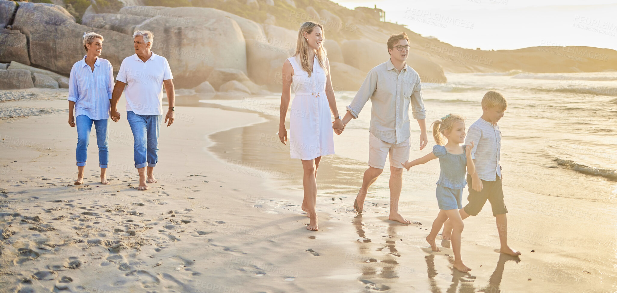 Buy stock photo Family generations, walking and beach with sunset for men, women and children with love on holiday. Parents, grandparents and kids by ocean, holding hands and bond on summer vacation with solidarity