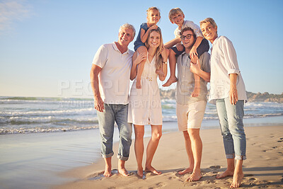 Buy stock photo Portrait of a senior caucasian couple at the beach with their children and grandchild. Happy family relaxing on the beach having fun and bonding