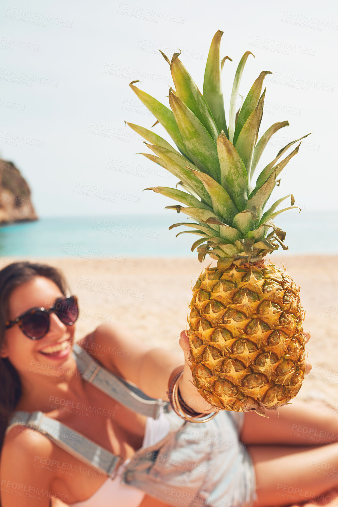Buy stock photo Pineapple, travel and portrait of a woman on the beach to relax on holiday or vacation during summer. Relax, smile and a happy young person with fruit on the sand by the ocean or sand for tourism