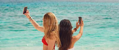 Buy stock photo Beautiful girl friends taking selfies with smart phone technology on paradise beach destination summer wanderlust vacation