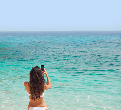 Buy stock photo Beautiful woman taking photos with smart phone technology on paradise beach destination summer wanderlust vacation