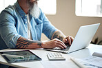 businessman with tattoos using latop computer typing messages browsing online working sitting at table