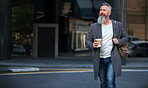 confident mature businessman man walking in city street holding coffee enjoying urban lifestyle