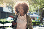 beautiful african american woman using smartphone smiling looking confident in city street on sunny day