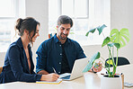 Two business people using laptop computer colleagues working in office sharing ideas