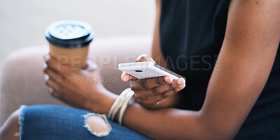 Woman using smartphone browsing messages on social media texting on mobile phone holding coffee