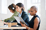 african american woman using digital tablet computer browsing internet sitting at table working with colleagues