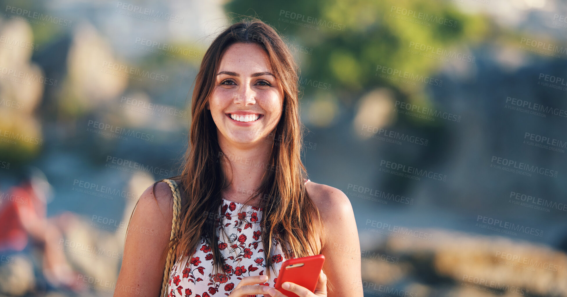 Buy stock photo Beautiful woman smiling on beach at sunset holding smartphone enjoying travel vacation lifestyle
