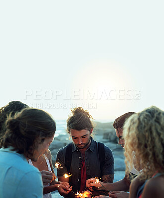 Buy stock photo friends with sparklers celebrating new years eve on beach at sunset