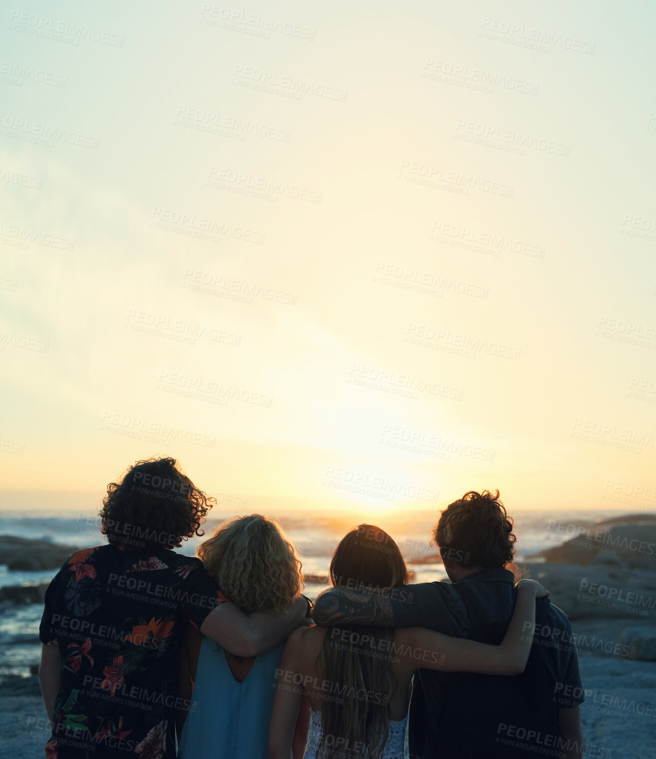 Buy stock photo group of friends embrace on beach looking at beautiful sunset enjoying summer vacation lifestyle