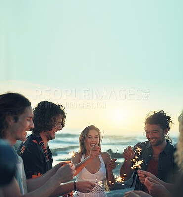 Buy stock photo friends with sparklers celebrating new years eve on beach at sunset