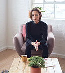 Portrait beautiful woman sitting on sofa at home looking serious