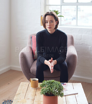 Buy stock photo Portrait beautiful woman sitting on sofa at home looking serious