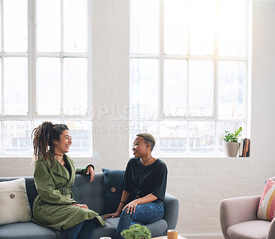 Buy stock photo two woman friends talking having conversation sitting on sofa at home